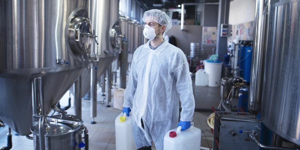 Worker carrying chemicals in a wine fermentation facility