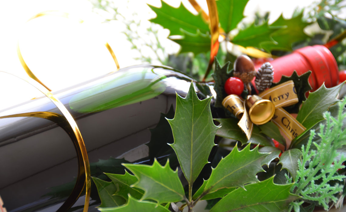 Christmas Wine Gift and Holly leaves and berries and Christmas decoration