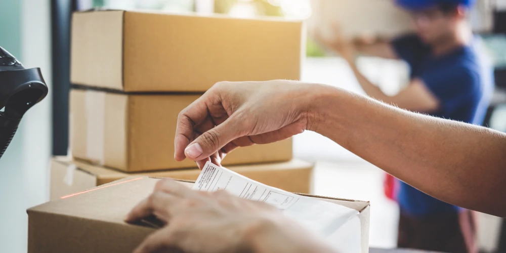 Delivery company preparing paperwork and boxes for shipping