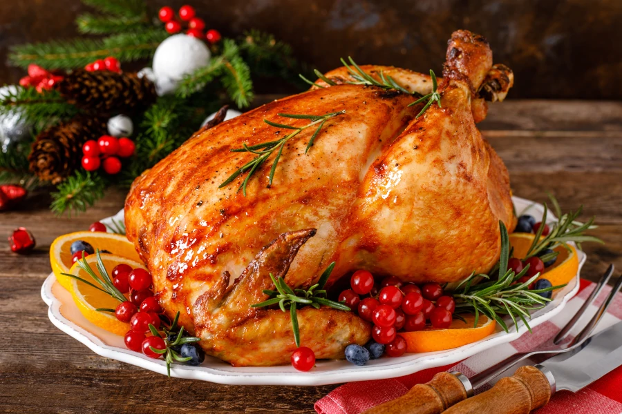 Christmas roasted turkey on the plate with red berries