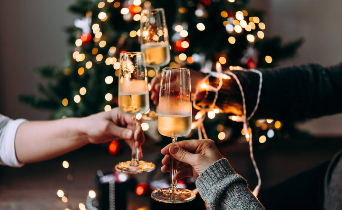 Friends toasting with sparkling wine at Christmas party