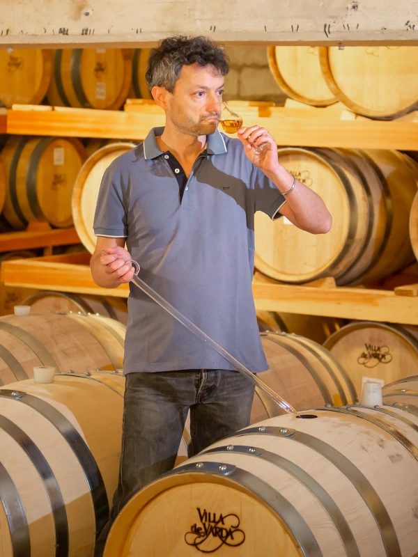 Mauro Dolzan, master distiller at Villa de Varda, Trentino, taking samples of grappa
