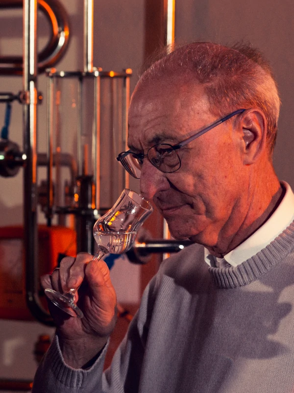 Mr Luigi Dolzan, tasting grappa after distillation, Villa de Varda, Trentino