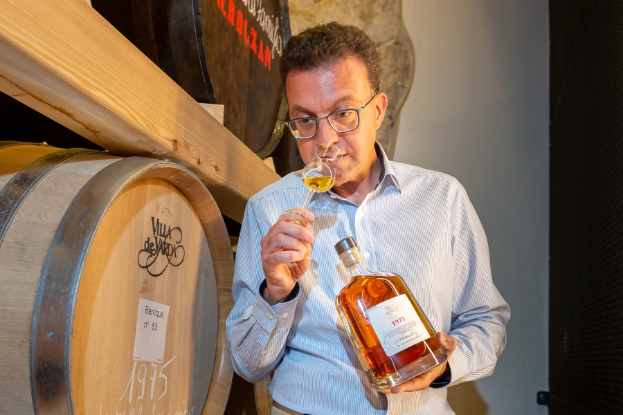 Michele Dolzan, Villa de Varda, in the ageing room, tasting oak-aged grappa from the glass