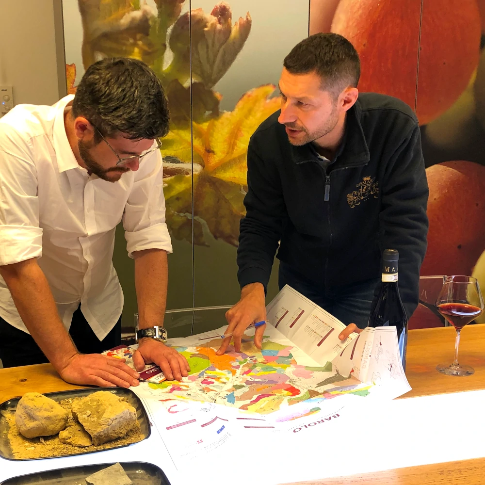 Oleg, director of Independent Wine, and Paolo Demarie discussing positions of vineyards in Barolo