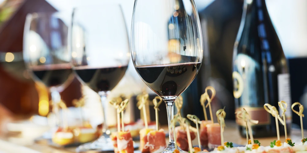 Glasses of red wine with canape nibbles on a wedding party table