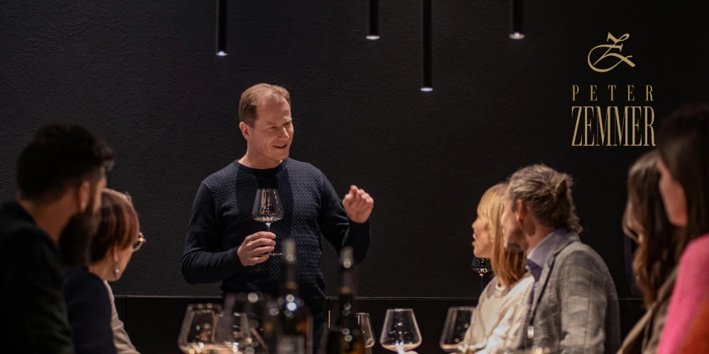 Winemaker Peter Zemmer conducting wine tasting with customers in his cellar in Cortina, Alto Adige, Italy